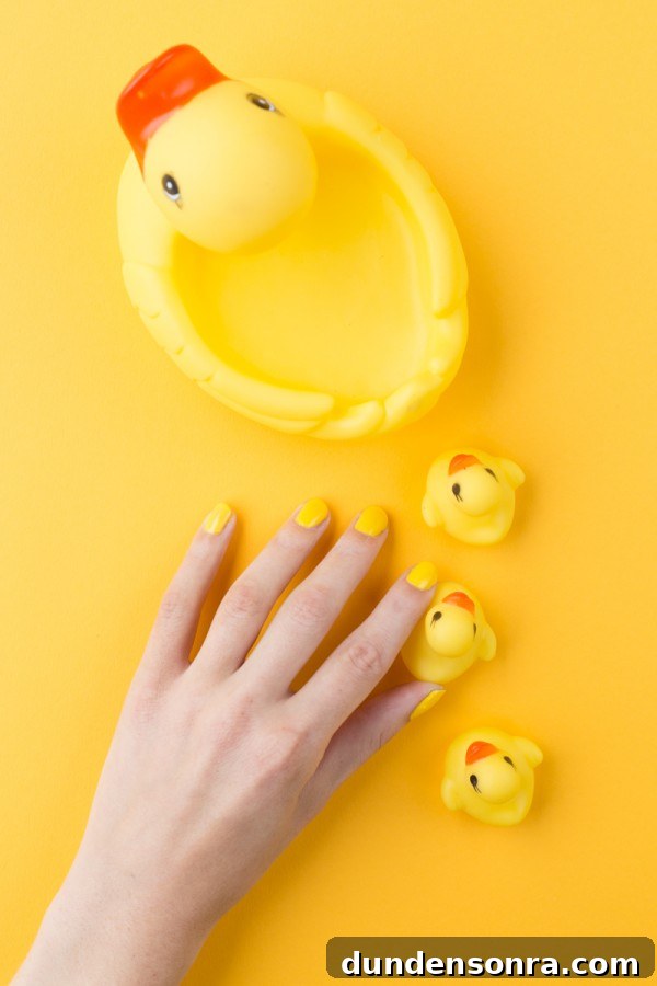 A hand and rubber duck