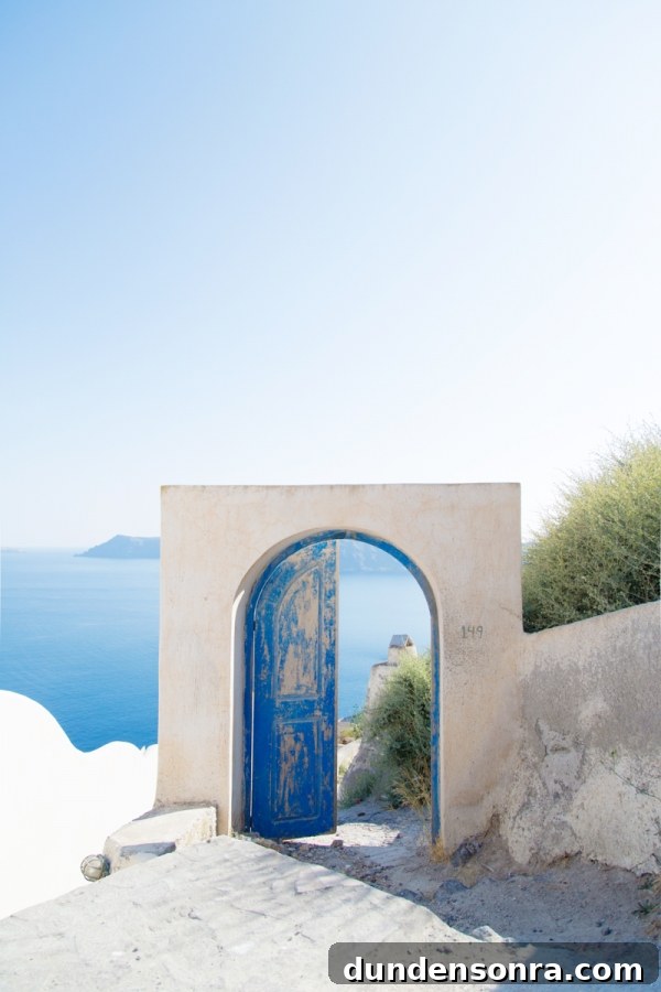 Honeymoon in Santorini: Meet the Mindells' Romantic Getaway 2 A door frame with blue doors