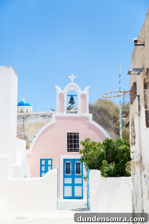 Honeymoon in Santorini: Meet the Mindells' Romantic Getaway 13 A pink building with blue doors