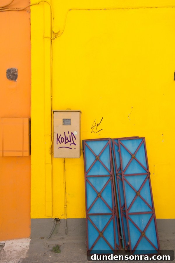 Honeymoon in Santorini: Meet the Mindells' Romantic Getaway 15 A yellow and orange building with blue windows