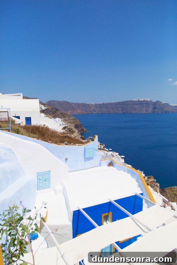 Honeymoon in Santorini: Meet the Mindells' Romantic Getaway 23 White building with blue windows on the coast