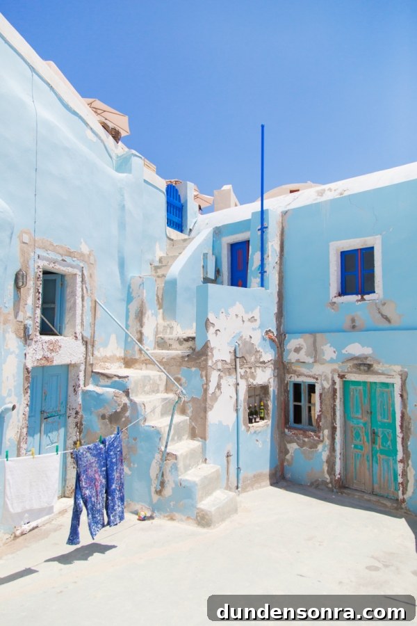 Honeymoon in Santorini: Meet the Mindells' Romantic Getaway 30 Blue building with blue windows and doors