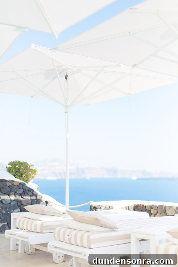 Honeymoon in Santorini: Meet the Mindells' Romantic Getaway 10 A white chair with umbrella