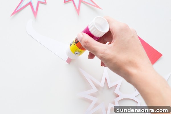 Someone gluing paper