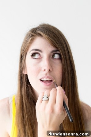 A woman getting her lips painted 