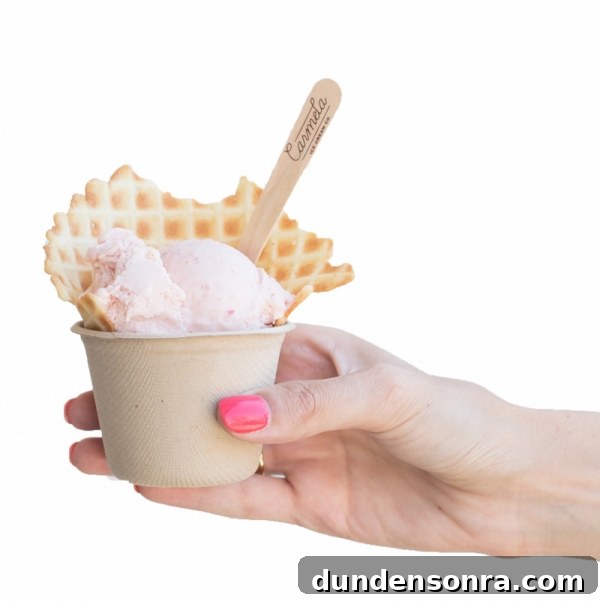 Someone holding a cup with ice cream