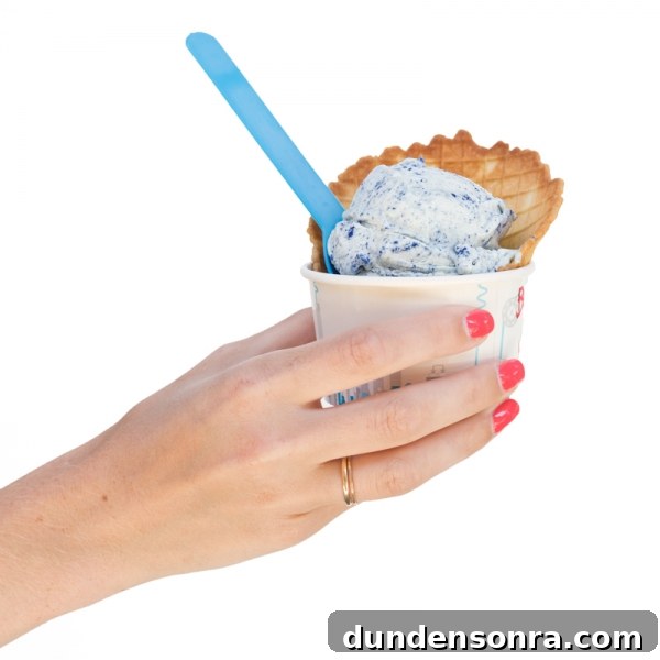 Someone holding a cup with ice cream