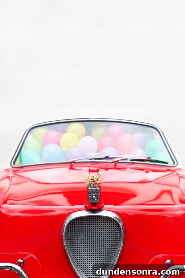 A red car with balloons inside of it
