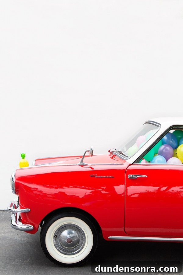A red car with balloons inside of it