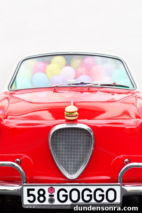 A red car with balloons inside of it
