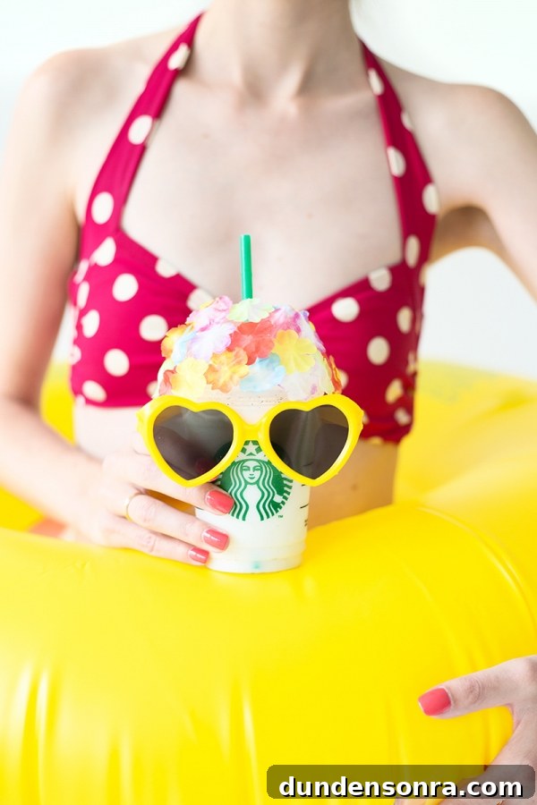 DIY Retro Swim Frappuccinos: Make Vintage Poolside Drinks at Home 4 Someone holding a starbucks drink with yellow sunglasses on it