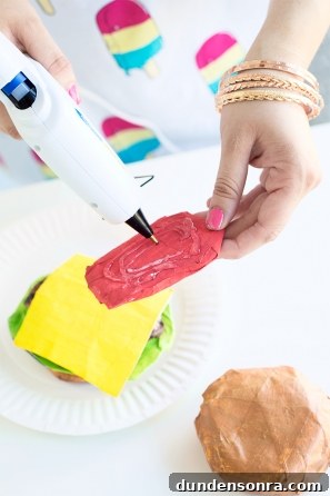 DIY Paper Mache Burger and Fries Craft (Plus Giveaway) 12 Someone gluing a paper mache burger