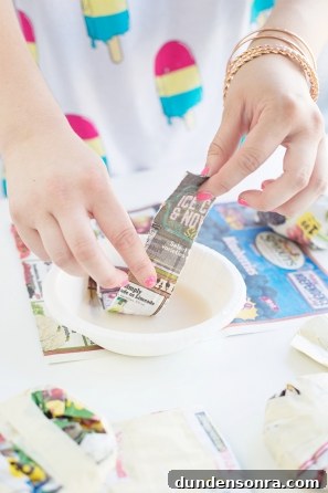 DIY Paper Mache Burger and Fries Craft (Plus Giveaway) 8 Someone holding newspapers