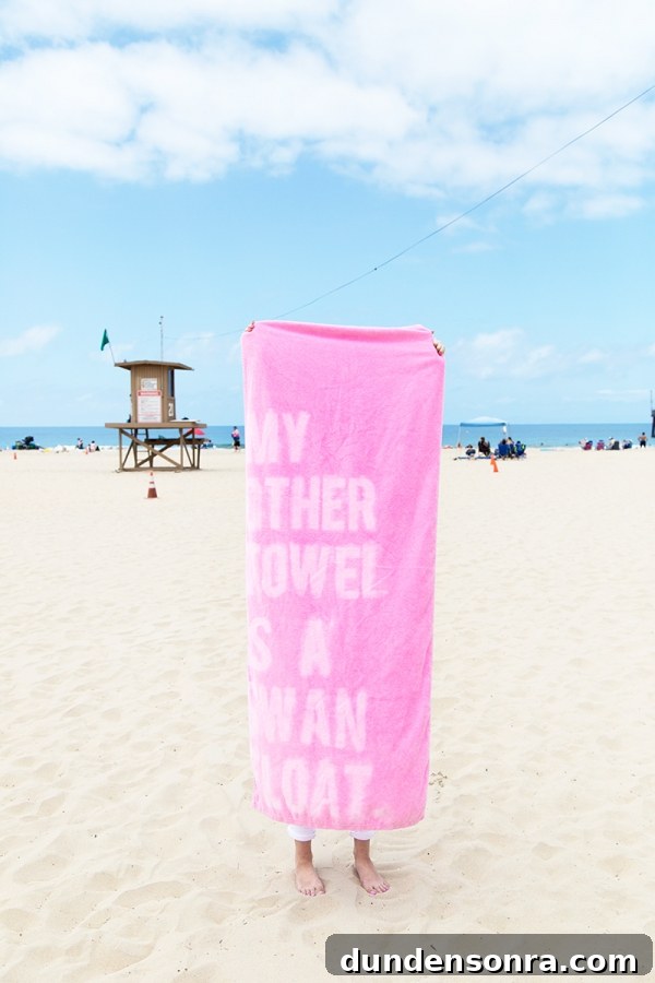 Someone holding a pink towel with words on it