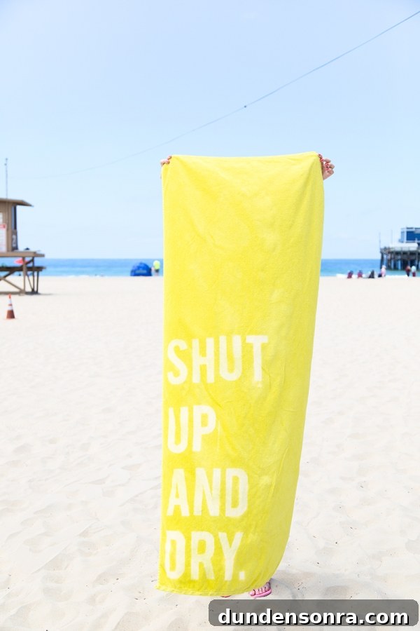 Someone holding a yellow towel that says "shut up and"