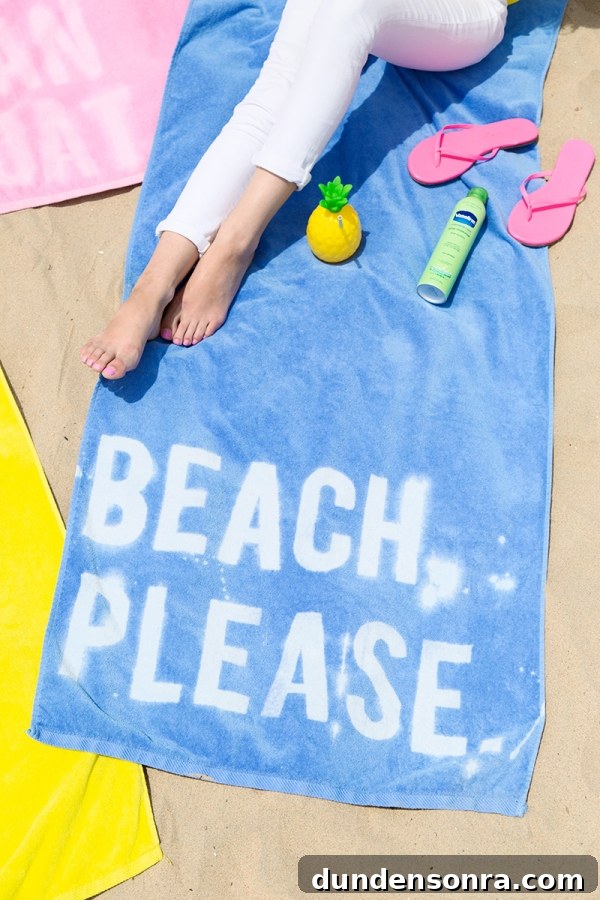 Blue towel that says "beach please"