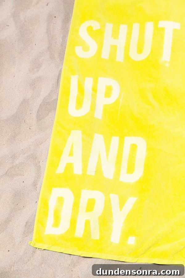 A close up of a yellow towel with words on it