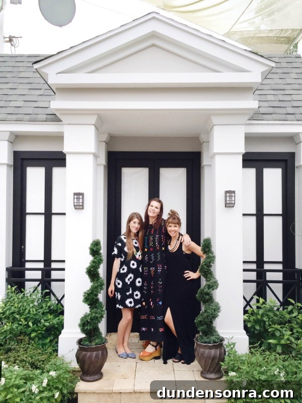 Three women standing in front of a building