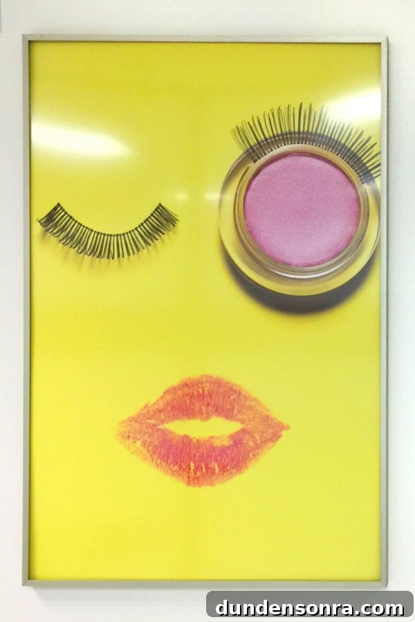 A photo of fake eyelashes and lipstick in a frame