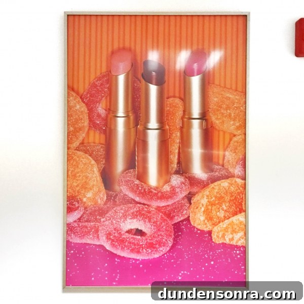 A photo of lipstick and candy in a frame