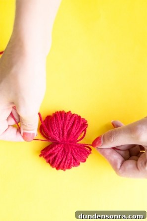 Someone wrapping red string