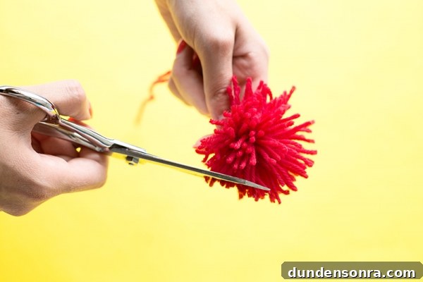 DIY Ice Cream Sneakers: How to Paint and Customize Your Shoes 14 Someone cutting a red pom pom