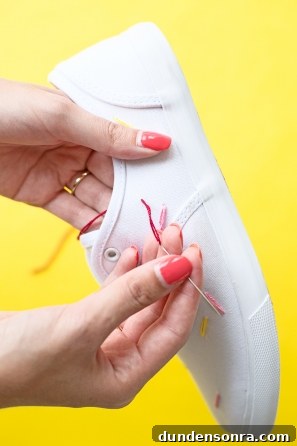 DIY Ice Cream Sneakers: How to Paint and Customize Your Shoes 7 Someone holding a red string and white sneaker