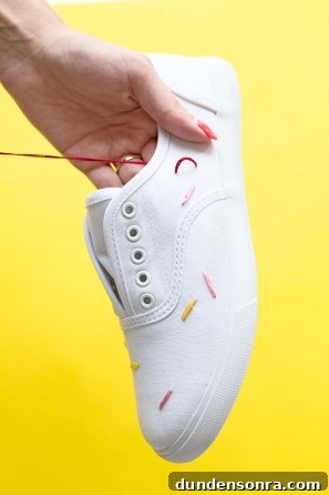 White sneakers with colorful strings on them