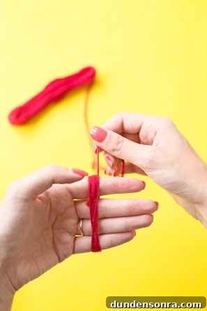 Someone wrapping red string