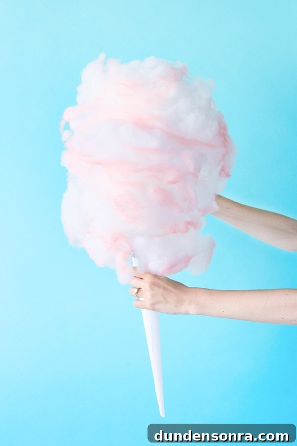How to Make a Cotton Candy Piñata for Parties and Birthdays 13 Someone holding fake cotton candy
