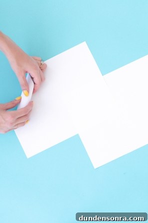 Someone folding a white paper