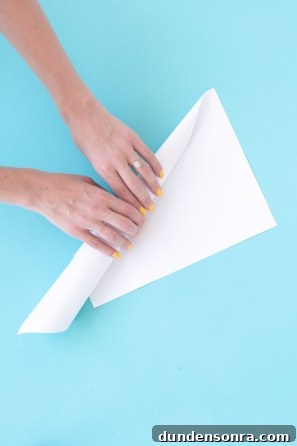 How to Make a Cotton Candy Piñata for Parties and Birthdays 10 Someone rolling white paper