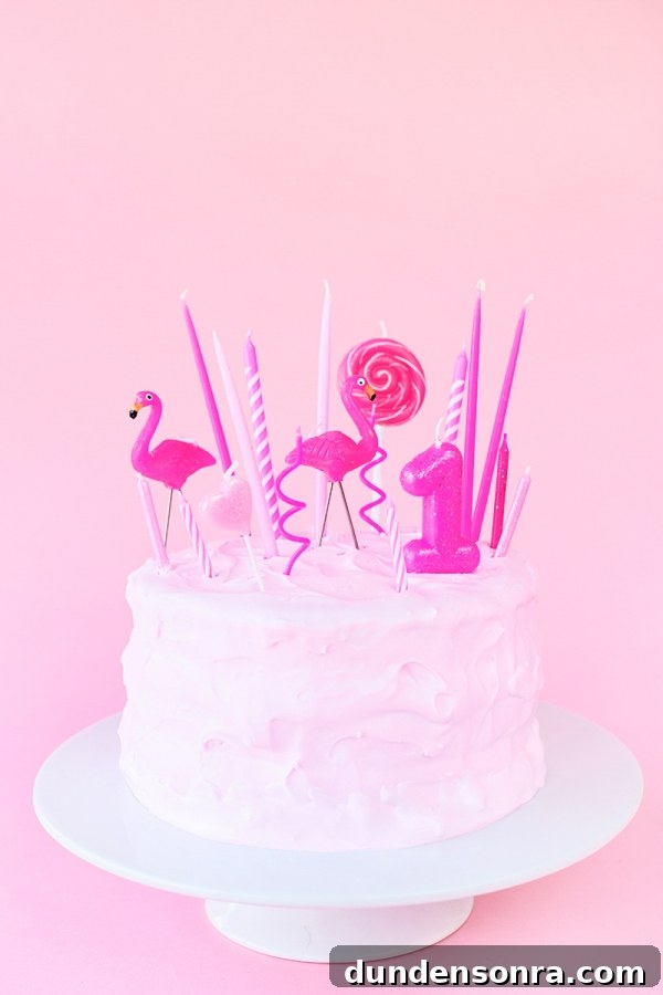 Pink cake with pink candles on it