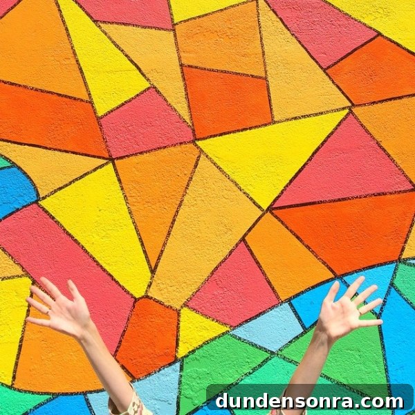 Studio DIY Wall Crawl: Top Murals and Walls to See in Los Angeles 12 Someone standing in front of a colorful mural