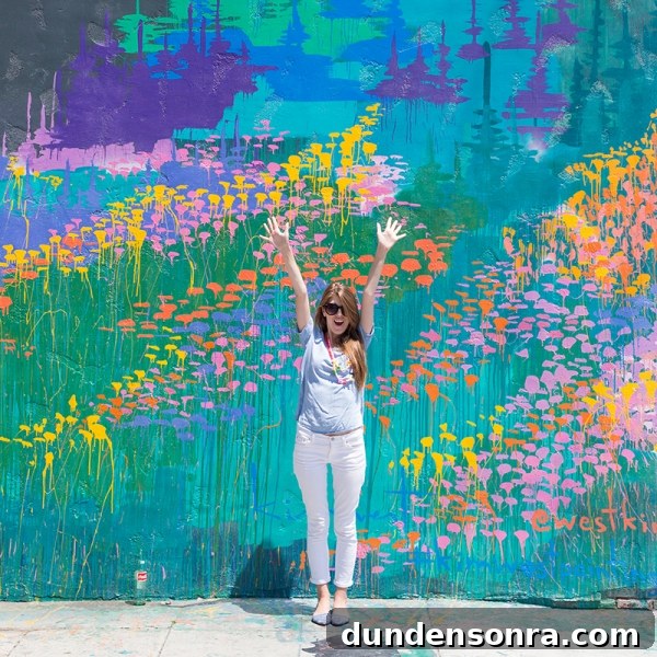Studio DIY Wall Crawl: Top Murals and Walls to See in Los Angeles 13 A woman standing in front of a colorful mural
