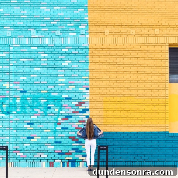 Studio DIY Wall Crawl: Top Murals and Walls to See in Los Angeles 14 A woman in front of a colorful wall