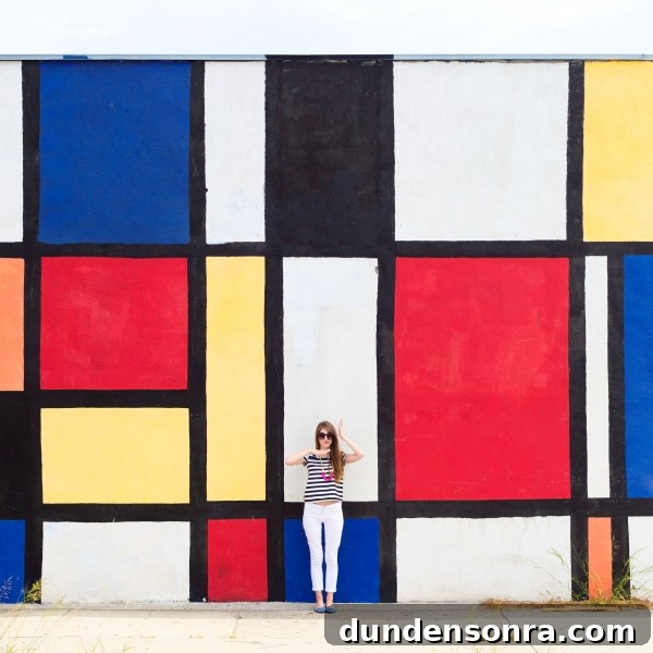 A person standing in front of a colorful wall