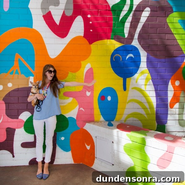 Studio DIY Wall Crawl: Top Murals and Walls to See in Los Angeles 6 A woman in front of a colorful mural