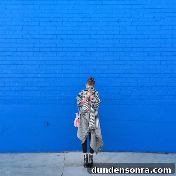 A woman in front of a blue wall