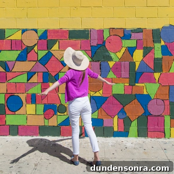 Studio DIY Wall Crawl: Top Murals and Walls to See in Los Angeles 9 A woman in front of a colorful wall