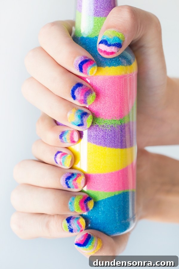 Someone holding rainbow powder in a jar