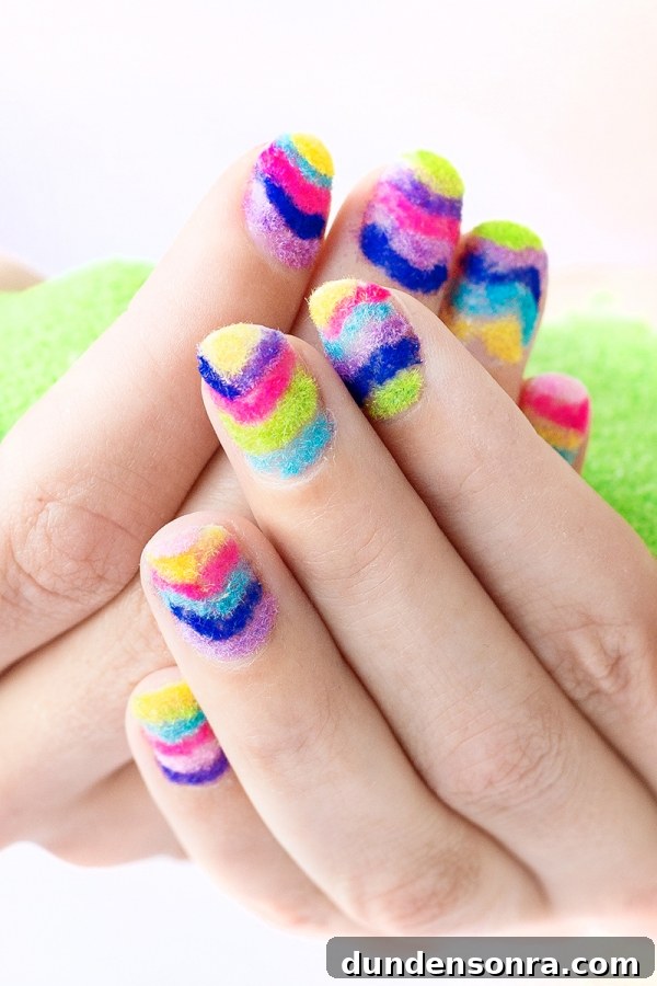Hands with rainbow powder nails