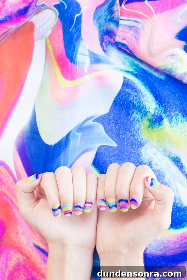Hands with rainbow powder nails