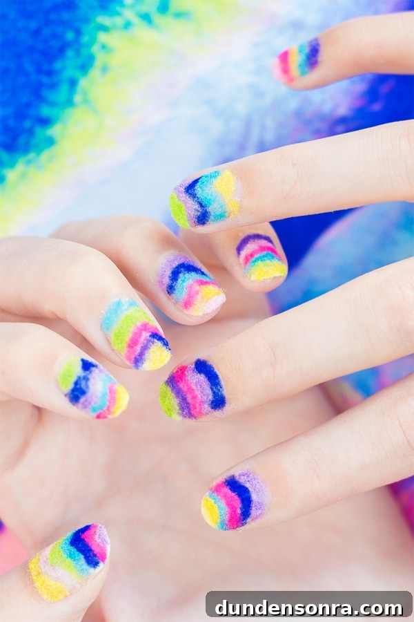 Hands with rainbow powder nails 
