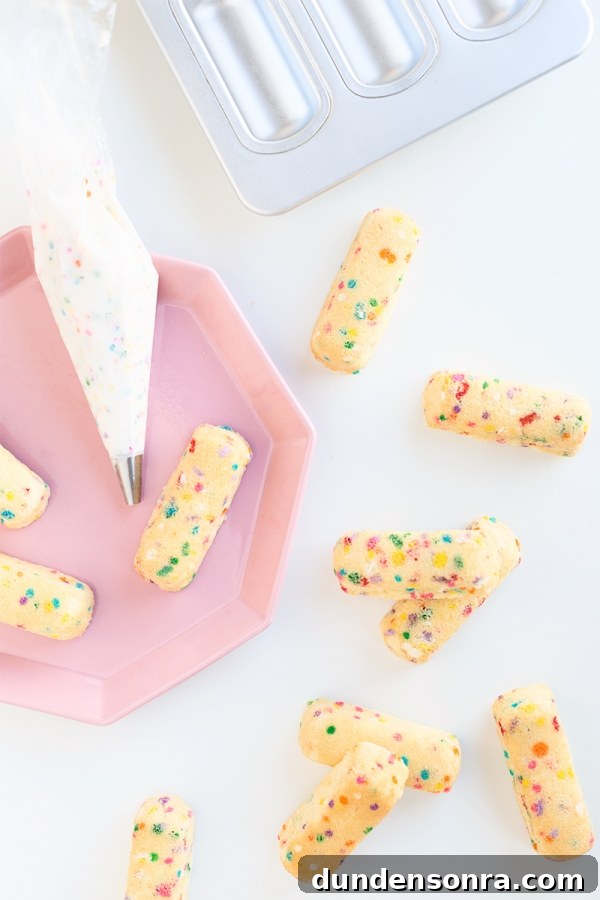 Funfetti Twinkies: Colorful Sprinkle-Stuffed Snack Cakes 7 Rainbow twinkies on a pink plate