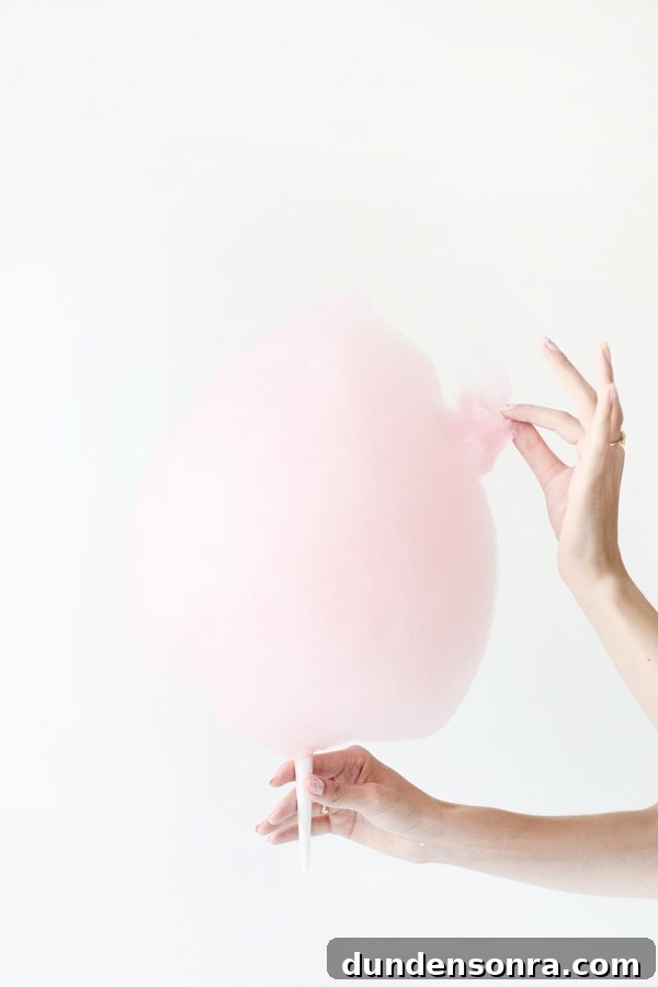 Someone eating pink cotton candy