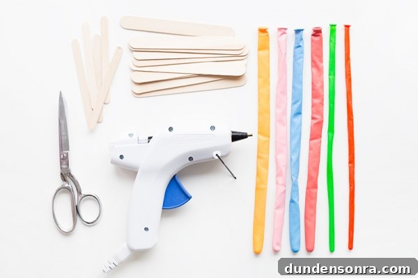 Summer Dreamsicle Party Ideas for a Bright, Refreshing Bash 19 Glue gun, wood sticks, and rainbow balloons