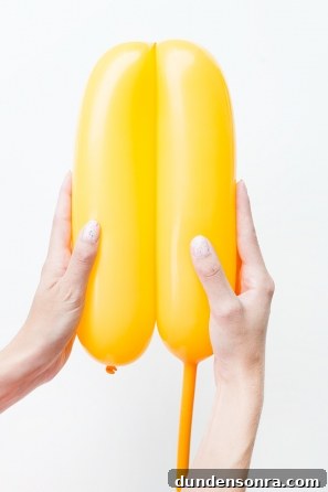 Summer Dreamsicle Party Ideas for a Bright, Refreshing Bash 23 Someone holding a yellow balloon