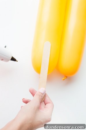 Summer Dreamsicle Party Ideas for a Bright, Refreshing Bash 25 Wood stick and yellow balloon