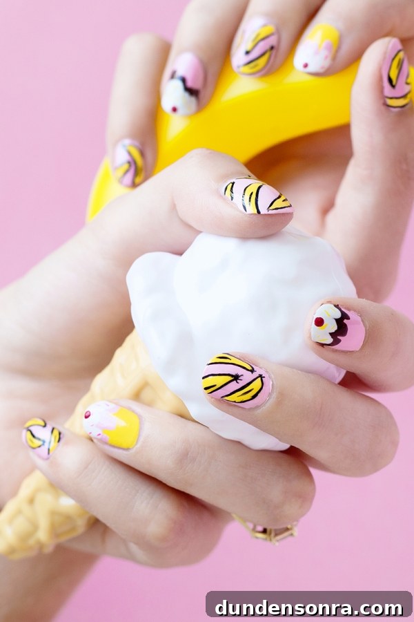 Banana Split Nail Art Ideas: Fun DIY Manicure Designs 3 Someone holding fake ice cream with banana split nails